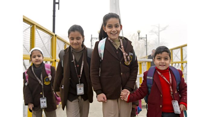 Joyful students head home after announcement of winter vacation in Srinagar on Saturday.