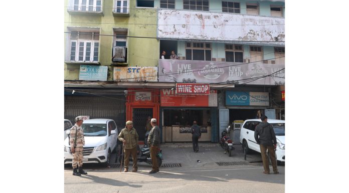 Cops deployed outside a wine shop in Jewel area of Jammu during search and seizure operation by the Income Tax Department on Wednesday. -Excelsior/Rakesh