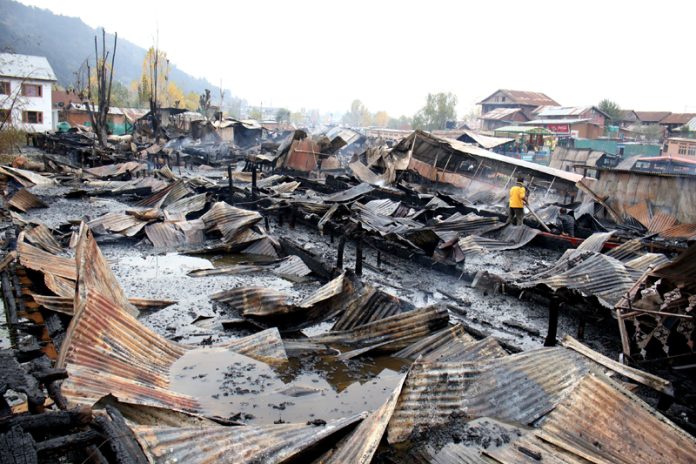 Houseboats gutted in a massive fire in Dal lake on Saturday. - Excelsior/Shakeel