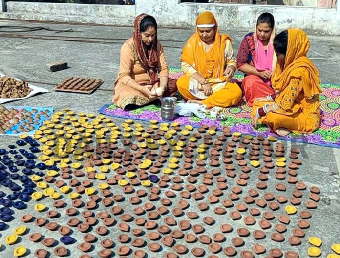 A group of women in Mishriwalla village near Jammu working tirelessly to create eco-friendly cow dung Diyas for Diwali festival.