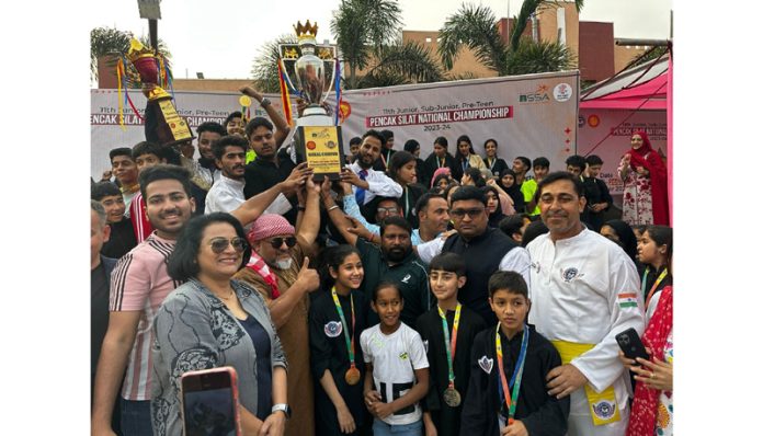 Jammu and Kashmir Pencak Silat team posing with trophy in Bihar during National Championship. 