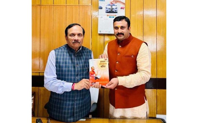 Mahant Rohit Shastri presenting a book to Rajeev Rai Bhatnagar, Advisor to J&K LG.