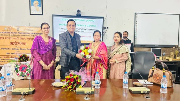 Principal of Govt Polytechnic Jammu presenting bouquet to Assistant Director Handicrafts during a workshop.