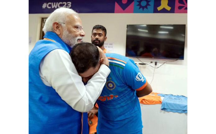 Prime Minister Narendra Modi with Indian cricketer Mohammed Shami during a meeting with the team in the dressing room at the Narendra Modi Stadium during the ICC Men’s Cricket World Cup 2023 final match between India and Australia, in Ahmedabad on Sunday. (UNI)