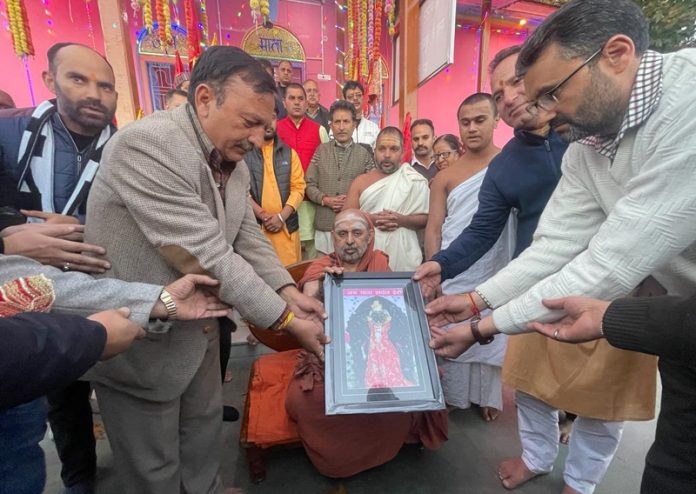 Shankaracharya Shankar Bharti Swamiji Mahraj during his visit to Shri Sarthal Mata temple Kishtwar being presented a portrait of the Mata by Vice Chairman of the Trust, Sanjeev Parihar, former Minister, Sunil Sharma and other trustees.