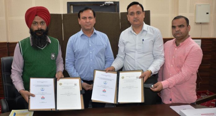 Principal of Govt Polytechnic Jammu and VC DAV University Jalandhar displaying copies of MoU signed between the two institutes.