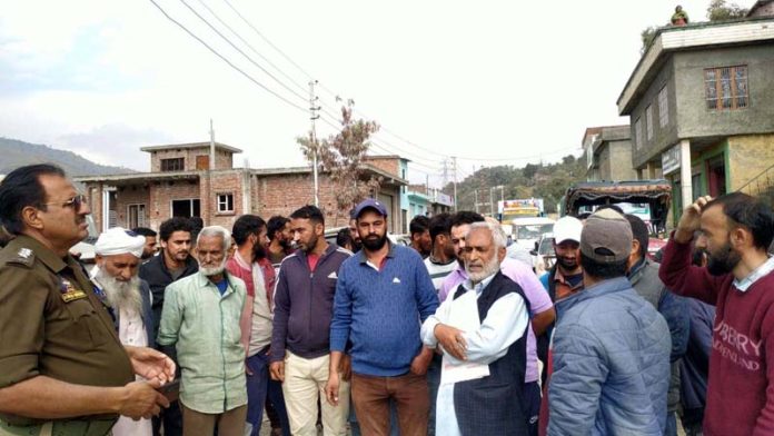 Villagers blocking Rajouri-Thanna road at Behrote on Thursday. -Excelsior/Imran