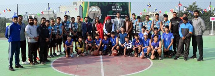 Players of different schools posing with dignitaries during Inter-School Basketball C'ship at Jammu.