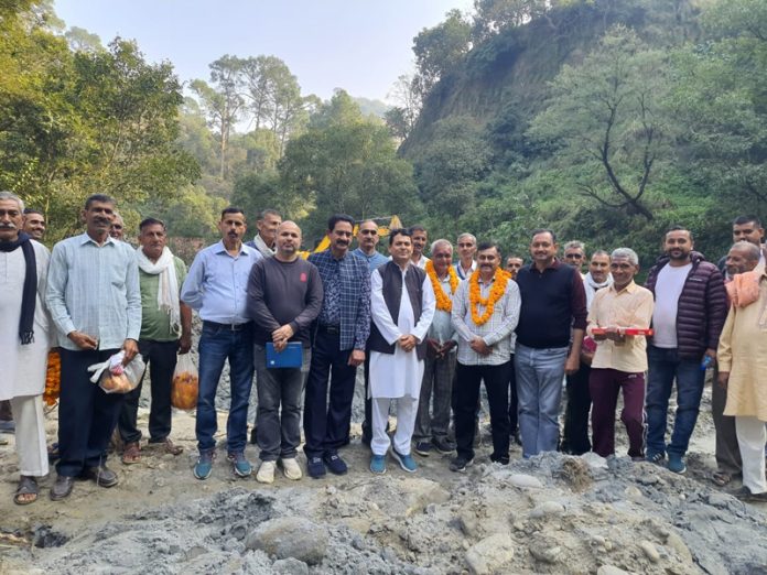 BJP leader, Suresh Sharma posing for a photograph with others after starting water projects in Chowki Choura.