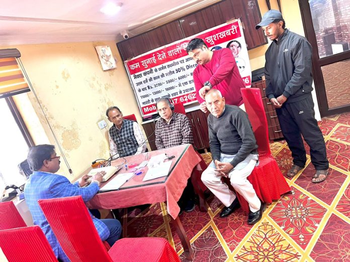 A doctor along with patients during a hearing check up camp at Kathua.