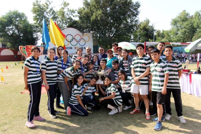 Enterprise House team of Jodhamal posing with trophy during annual sports meet.