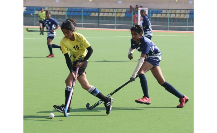 Girls in action during a hockey match at K K Hakku Stadium, Jammu on Saturday. —Excelsior/Rakesh