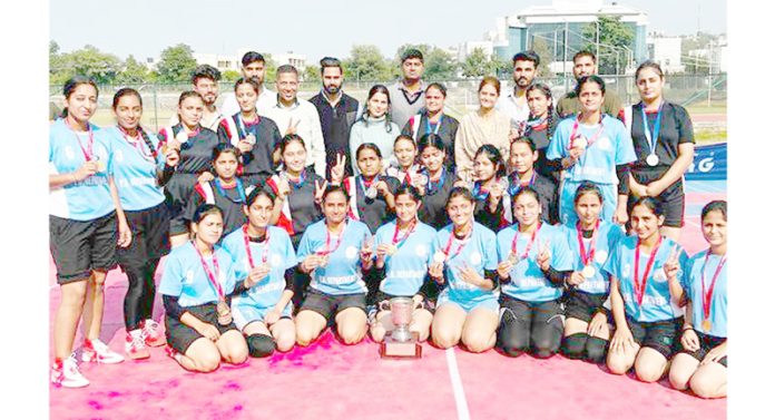 Kabaddi team of P.G Department of Jammu University (Women) posing with trophy on Wednesday.