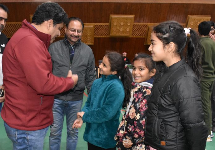 Secretary YSS Sarmad Hafeez interacting with little badminton players at Sher-i-Kashmir Indoor Sports Complex in Srinagar.