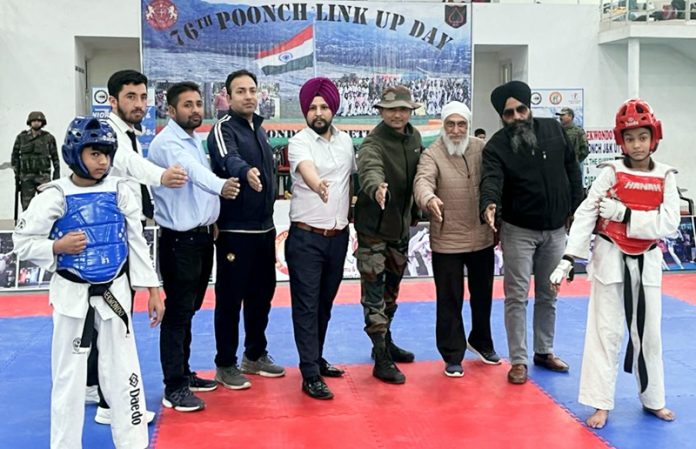 Lieutenant Colonel Gaurav Thapa posing with Taekwondo players and dignitaries at Poonch.