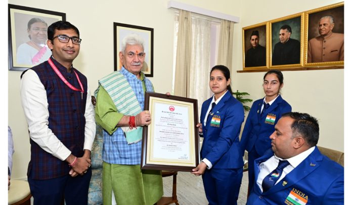 Lieutenant Governor Manoj Sinha presenting Certificate of Excellence Award to SMVDSB Para Archers On Wednesday.
