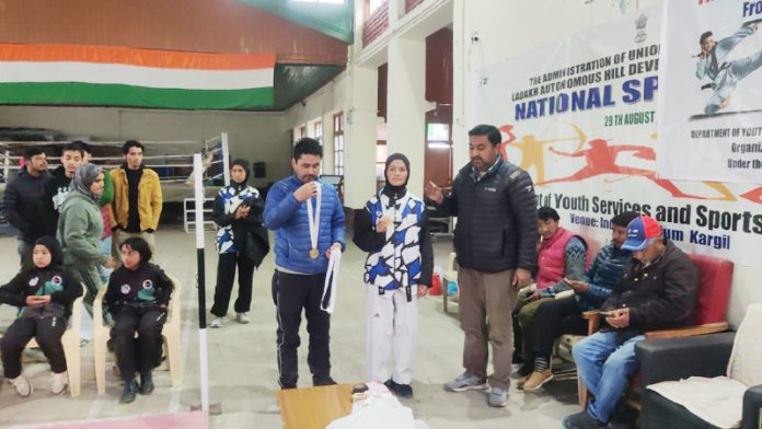 Chief Guest presenting medal to winner in Kargil during 13th District Kargil Taekwondo Championship.