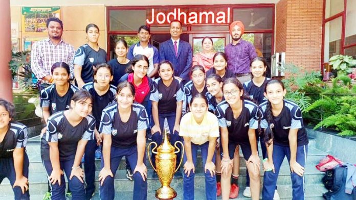 Boys and Girls football team of Jodhamal posing with trophies.