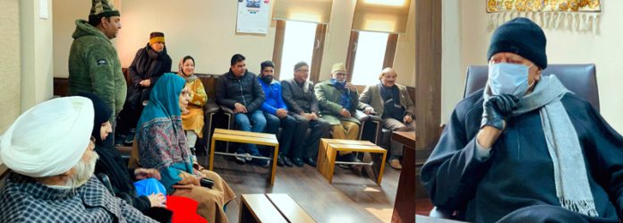 NC president Dr Farooq Abdullah interacting with party functionaries at Srinagar on Tuesday.