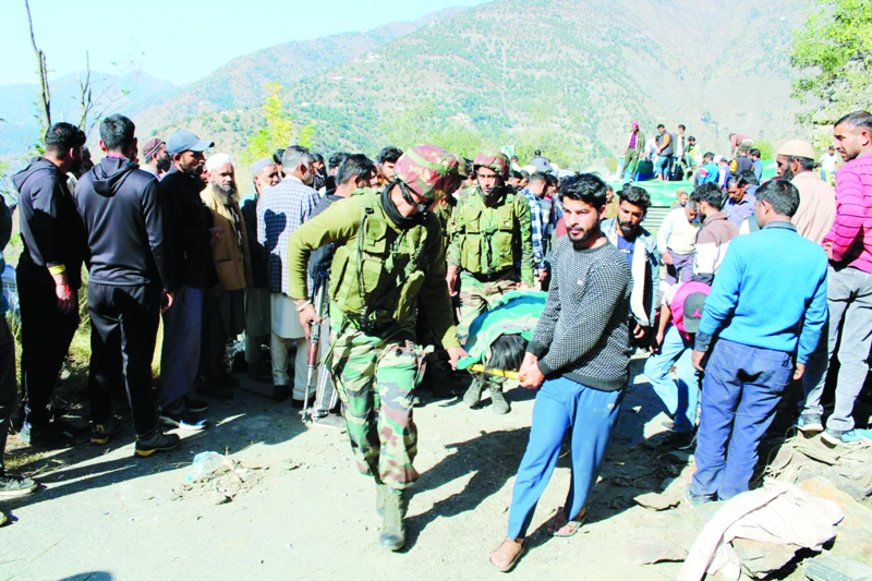 Army personnel along with locals shifting people injured in accident in Doda on Wednesday. -Excelsior/Tilak Raj