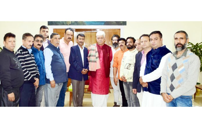 LG Manoj Sinha posing for a group photograph with a delegation on Sunday.
