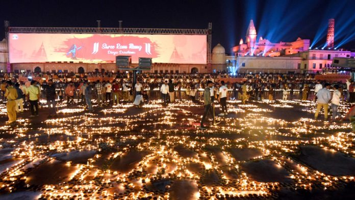 People lighting lamps at Ayodhya to mark Deepawali.