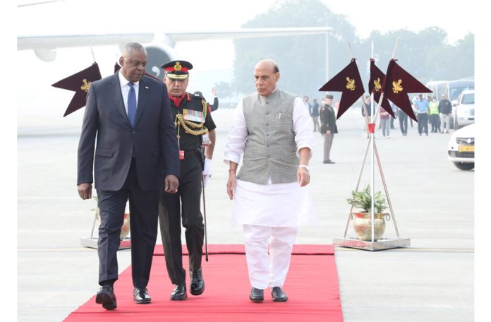 Defence Minister Rajnath Singh welcomes United States Secretary of Defense Lloyd Austin (L) upon his arrival at the AFS Palam, in New Delhi on Thursday.
