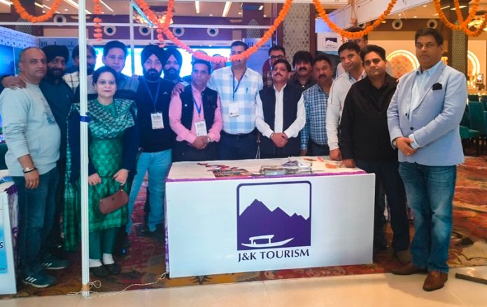 Tour organizers, travel agents and others posing for a group photograph at a Travel & Tourism Exhibition in Jammu on Saturday.