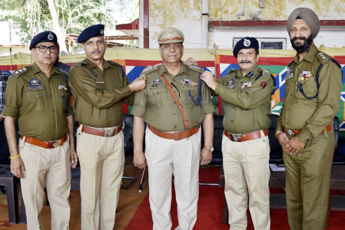 Shiv Kumar, Principal PTTI, Vijaypur decorating Surinder Paul with new rank on Monday.