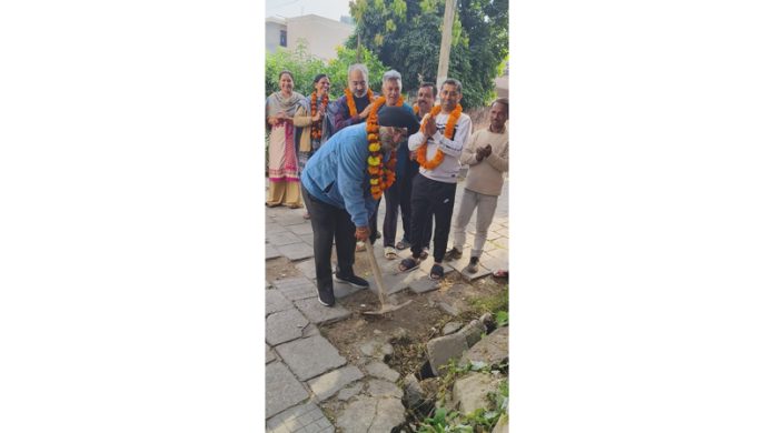 JMC Councillor, Inder Singh Soodan starts drain work in Guru Nanak Nagar on Monday.