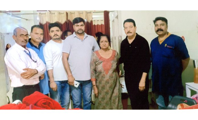 Dr Madan Gandotra along with his team posing for a photograph with the patient who underwent successful total knee replacement surgery at SVMM Hospital.