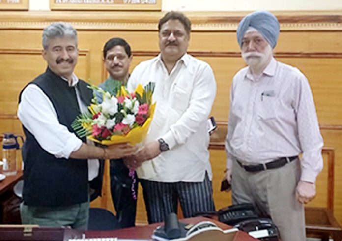 Kiran Watal presenting a flower bouquet to Director Industries and Commerce, Arun Manhas, in Jammu on Thursday.