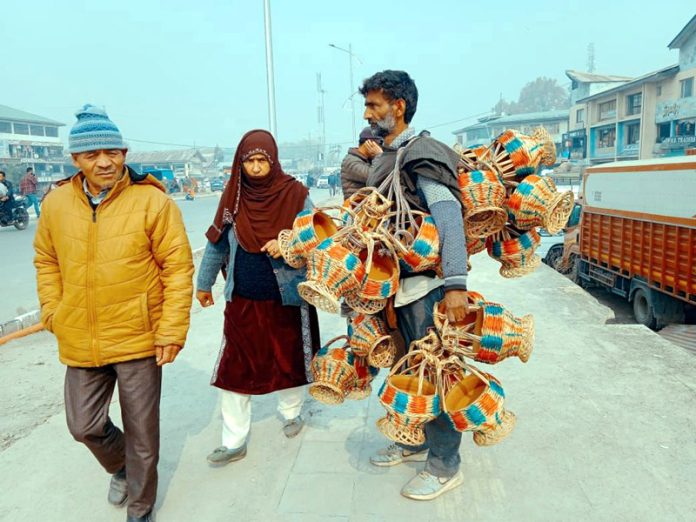 A street vendor selling traditional Kangris (fire pots) in Srinagar on Tuesday. (UNI)
