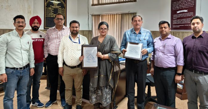 Principal GCET Jammu displaying copy of MoU signed with BIS Jammu.