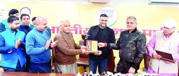 BJP leader Ashok Koul felicitating World C’ship medallist in Jammu on Friday.