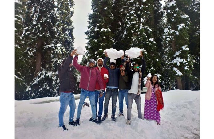 Tourists enjoying snow in famous tourist destination of Guldanda meadow in Bhaderwah area of Doda district on Saturday. -Excelsior/Tilak Raj