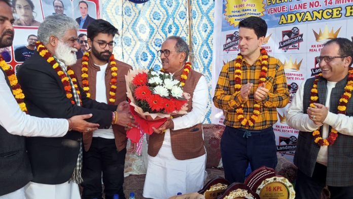 Chief Guest Dr Nirmal Singh receiving a Bouquet during a sporting event at Jagti.