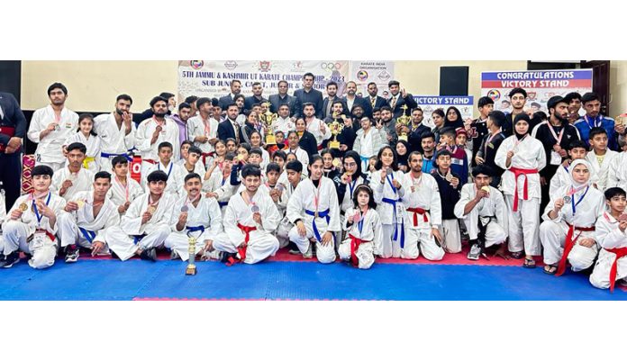 Karate players posing with dignitaries during the championship.