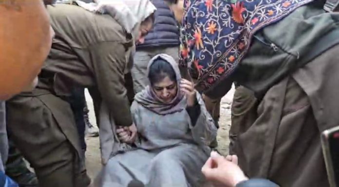PDP president Mehbooba Mufti being removed from road while sitting on dharna near Bafliaz in Poonch on Saturday. -Excelsior/Waseem