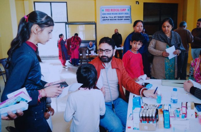 A doctor examining a child during a medical camp at Jammu on Sunday.