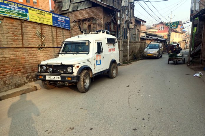 A security vehicle deployed outside the premises being searched by the SIA at Kulgam on Wednesday. -Excelsior/Sajad Dar