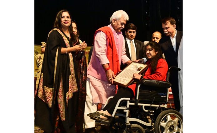 LG Manoj Sinha felicitating a Divyang during a function at Jammu on Sunday.