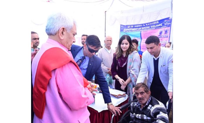 LG Manoj Sinha meeting a civilian during Viksit Bharat Sankalp Yatra at Nagbani in Jammu on Tuesday.