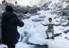 As Kashmir temperature continues to dip, tourists enjoy at freezed river Lidder at Chandanwari Pahalgam, in Anantnag district on Friday. (UNI)
