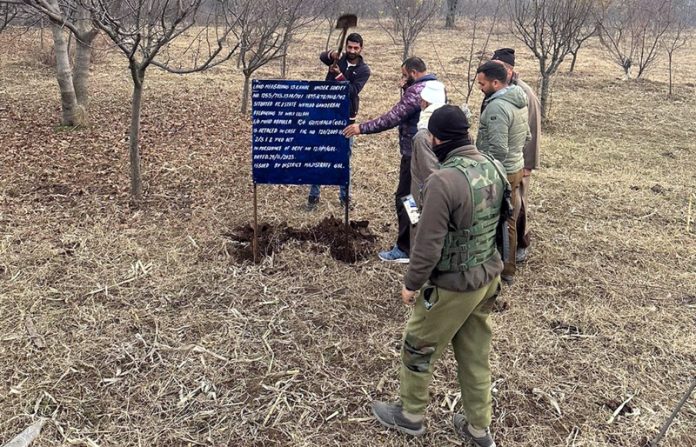 Property of a militant being attached in Ganderbal on Wednesday. -Excelsior/Firdous