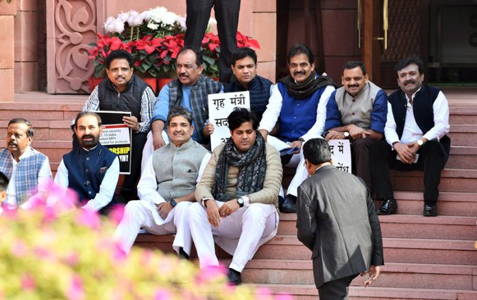 Suspended MPs sitting on a dharna at the stairs of Makar Dwar at Parliament House, in New Delhi on Monday.(UNI)