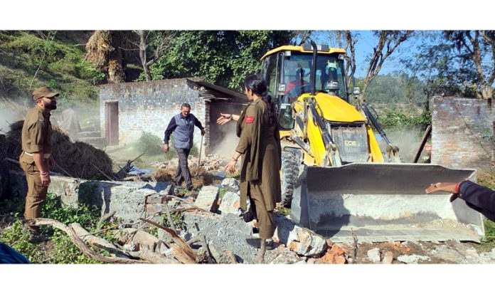 Revenue and police officials dismantling a structure erected illegally on a State land at village Bandraal Khurd, Chowki Choura in Jammu.