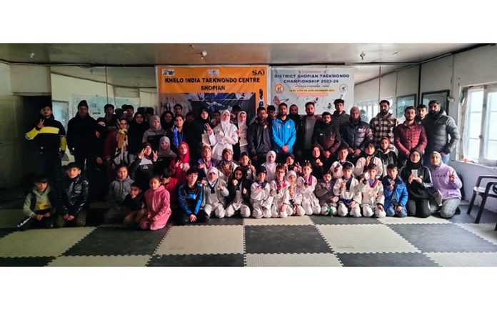 Taekwondo athletes posing with dignitaries during District Shopian Taekwondo Championship on Friday.