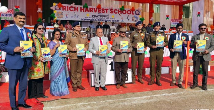 Inspector General of Police, Jammu Zone Anand Jain displaying Annual Newsletter while posing for a group photograph.