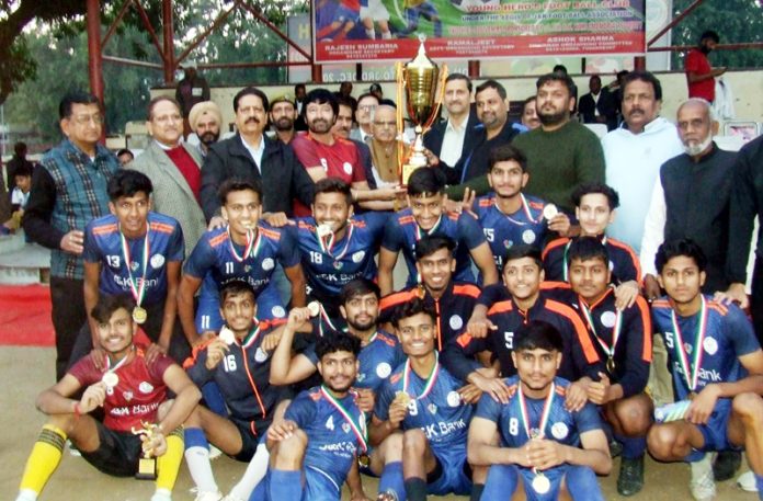 Jammu and Kashmir Bank Academy Football team posing with trophy on Monday.